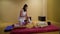 Woman doing Thai massage for man in wellness spa