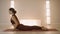 Woman doing upward facing dog pose on mat. Yoga trainer exercising in studio