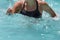 Woman Doing Water Aerobics in an Outdoor Swimming Pool