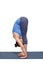 Woman doing yoga asana Uttanasana - standing forward bend