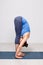 Woman doing yoga asana Uttanasana - standing forward bend