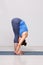 Woman doing yoga asana Uttanasana - standing forward bend