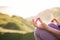 woman doing yoga in beautiful nature background at sunset or sunrise, focus on hand - mindfulness and mental health and hygiene