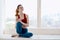 woman doing yoga exercise near the window relaxation