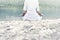 Woman doing yoga exercises in front of a spectacular mountain lake