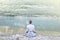 Woman doing yoga in front of a spectacular mountain lake