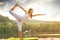 Woman doing yoga on the lake - beautiful lights