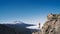 Woman doing yoga and meditating on background of natural landscape