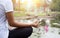 Woman doing yoga meditation next to lotus pond