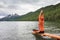 Woman is doing yoga at Multinskoe lake