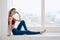 woman doing yoga near window relaxation meditation lifestyle