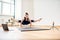 Woman doing yoga online. Computer and camera in her living room. Healthy lifestyle and distance work concepts