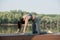 Woman doing yoga outdoors in a beautiful spot on a riverside