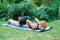 Woman doing yoga in the park, young girl doing various wellness exercises