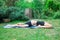 Woman doing yoga in the park, young girl doing various wellness exercises