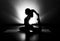 Woman doing yoga pigeon pose silhouette black and white