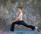 Woman doing Yoga posture high Lunge pose