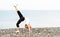 Woman doing yoga and sport exercises on beach