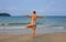 Woman doing yoga on sunny beach. Tropical seaside vacation activity. Young girl in asana posture.