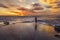 Woman doing yoga during the sunset falling over the sea