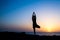 Woman doing yoga tree sunset silhouette