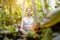 Woman doing yoga in the tropical jungle