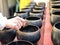 Woman donating money into Buddhist monk alms bowl for making merit