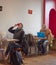 A Woman draining her Coffee Cup while a Man works on his laptop at their respective tables in the Red Kite Cafe.