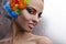 Woman with dramatic makeup and feather headdress
