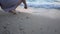 Woman drawing heart in the beach sand