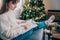 Woman drawing work-life balance wheel sitting on the sofa at home. Self-reflection and life planning for next new year