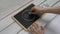 A woman draws a face with a smile on a table with chalk on a children\\\'s blackboard