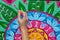 Woman draws a mandala, hand with a brush close-up