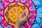 Woman draws a mandala, hand with a brush close-up