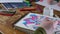 a woman draws neurographics in a notebook on a wooden table, drawing lessons with a child