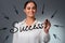 Woman draws `Success` lettering