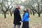 A woman with dreadlocks and a gas mask holds the hand of a man with steampunk goggles and a gas mask. Love in an