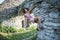 A woman in a dress is climbing a brick wall