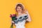 Woman in dress holding beautiful bouquet of flowers in front of blue background. Holiday gift valentine day, 14 february, March 8