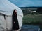 A woman in a dress near the traditional Mongolian dwelling yurt