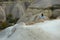 Woman In Dress Traveling In Nature, Standing At Rocks Valley