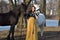Woman in dress with two horses in spring