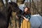 Woman in dress with two horses in spring