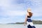 Woman in dress wear straw hat walking on beautiful  beach