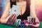 woman in dress wins a game of blackjack and is happy with all the chips after playing poker.