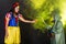 Woman dressed as fairytale character holds Radioactive atomic nuclear ionizing radiation danger warning symbol on apple