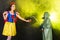 Woman dressed as fairytale character holds Radioactive atomic nuclear ionizing radiation danger warning symbol on apple