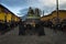 Woman dressed in black carrying a giant float in a street of the old city of Antigua during a procession of the Holy Week with a v