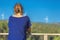 Woman dressed in blue, enjoying the river landscape