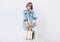 Woman dressed elegant outfit with oversize denim jacket and shopper bag. Modern fashion outfit concept image